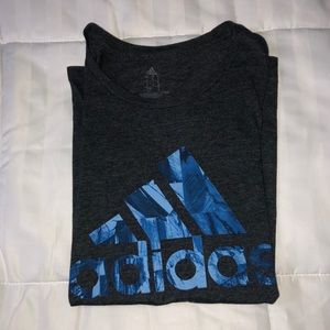 dark grey adidas shirt with blue 3 stripe logo